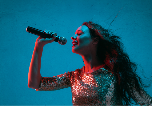 Singer with a microphone on a teal background