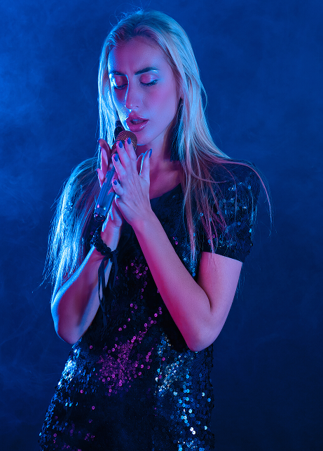Singer holding a microphone in blue light